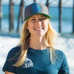 Headshot of Kelly Twichel on the beach wearing Access Trax merch和ise